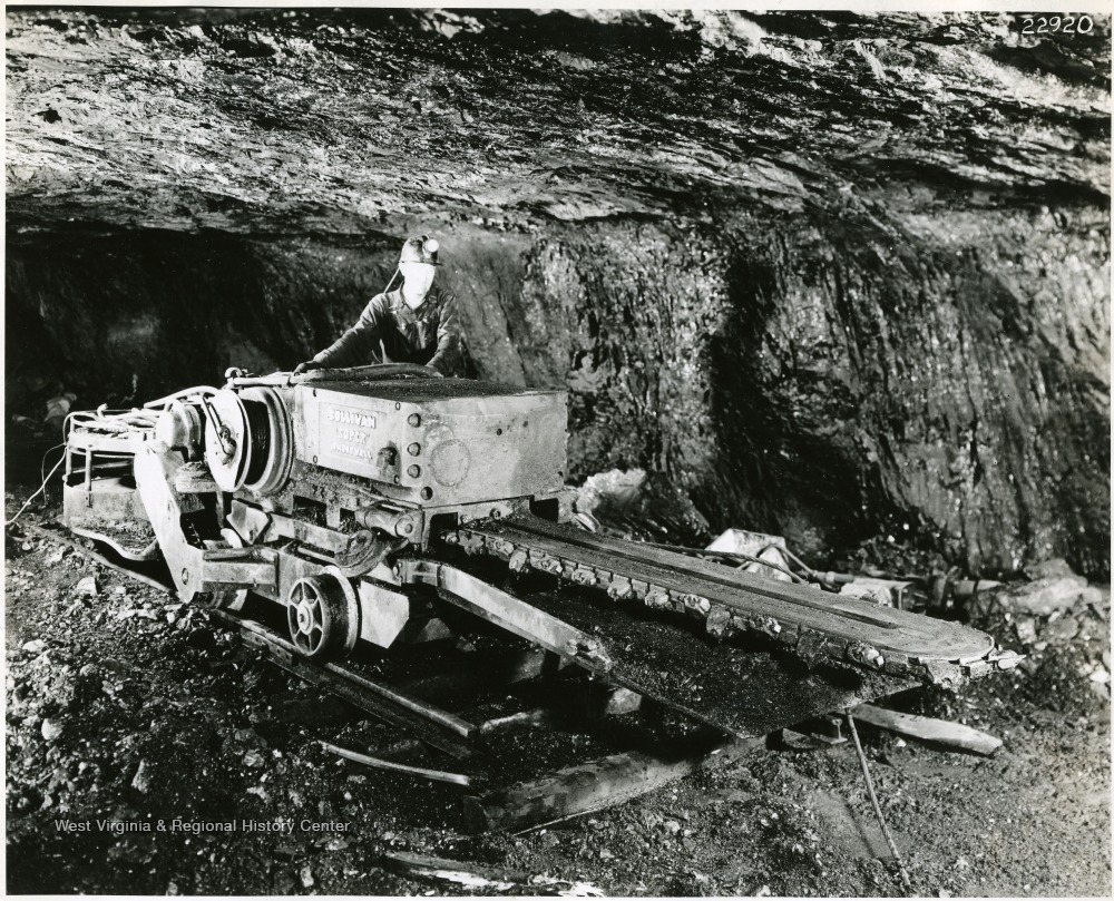 Miner on a small, track mounted, cutting machine.
