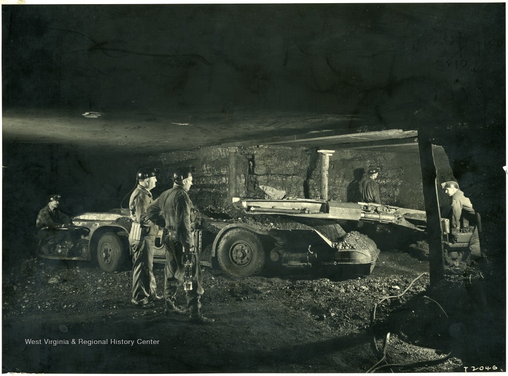 Miners operating a cutting machine. 