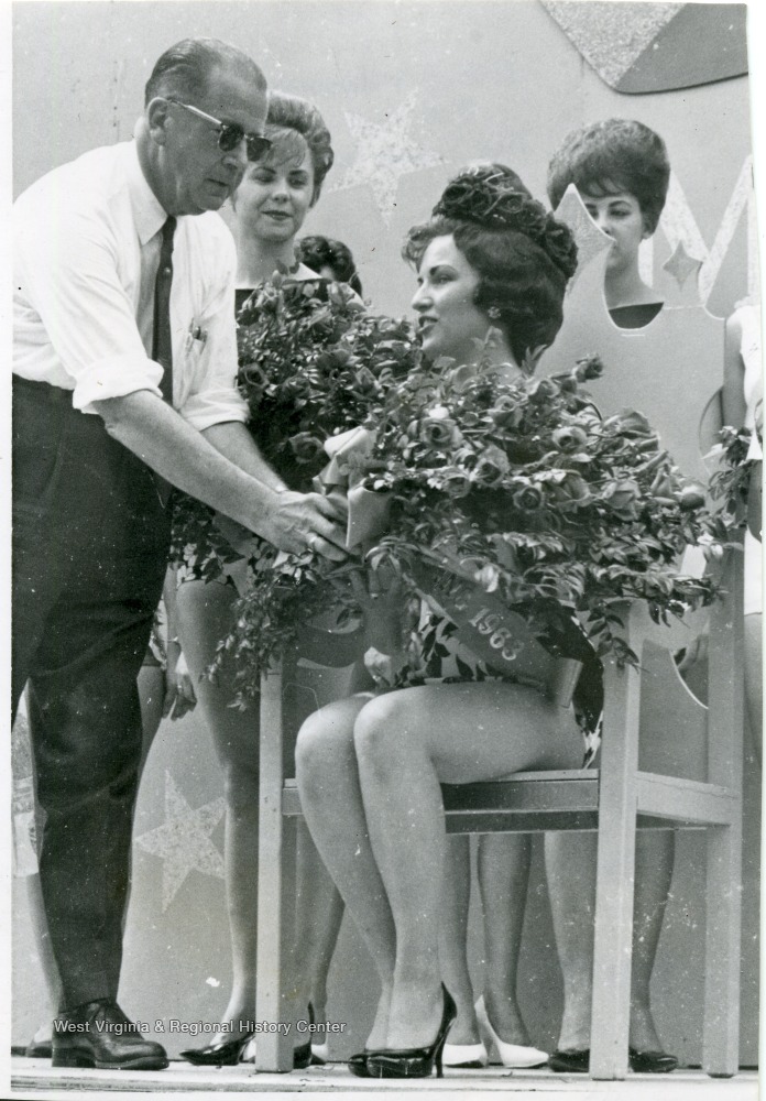 J. W. Ruby gives flowers to Miss Sterling Faucet at her coronation.