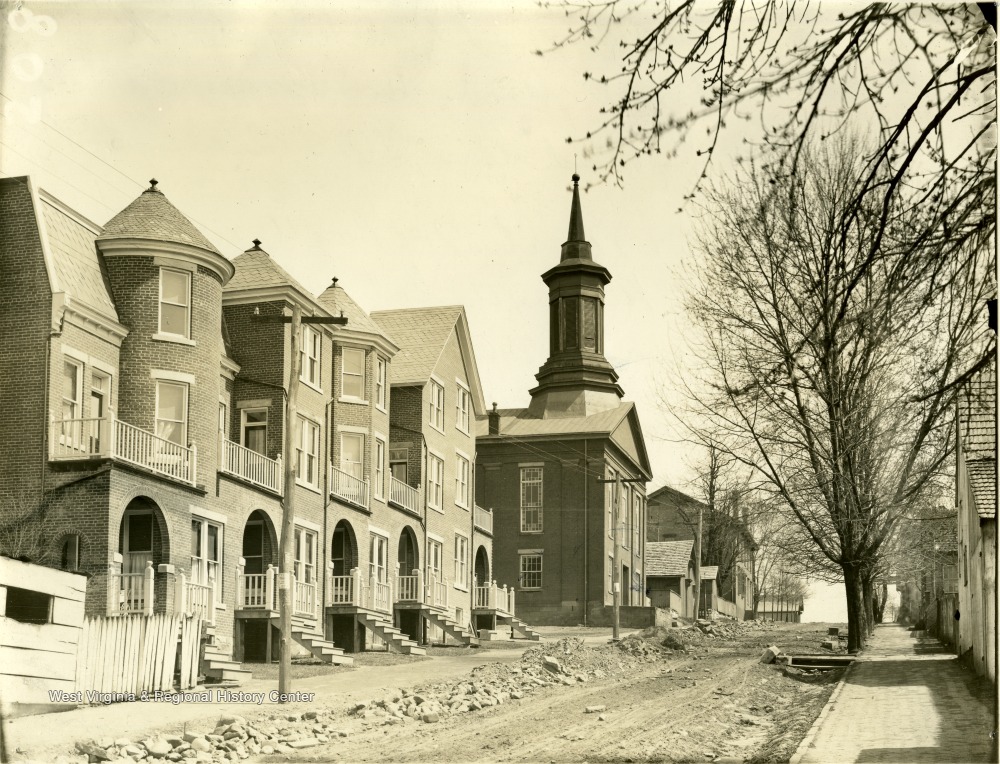 'Old Methodist Church on Brick Row. Commencement used to be held there. Dr. Martin, First President of the University (WVU), was presented with keys by the late Judge J. T. Hoke, who was a member of Board of Regents. 1867' 'Rufus A. West.'