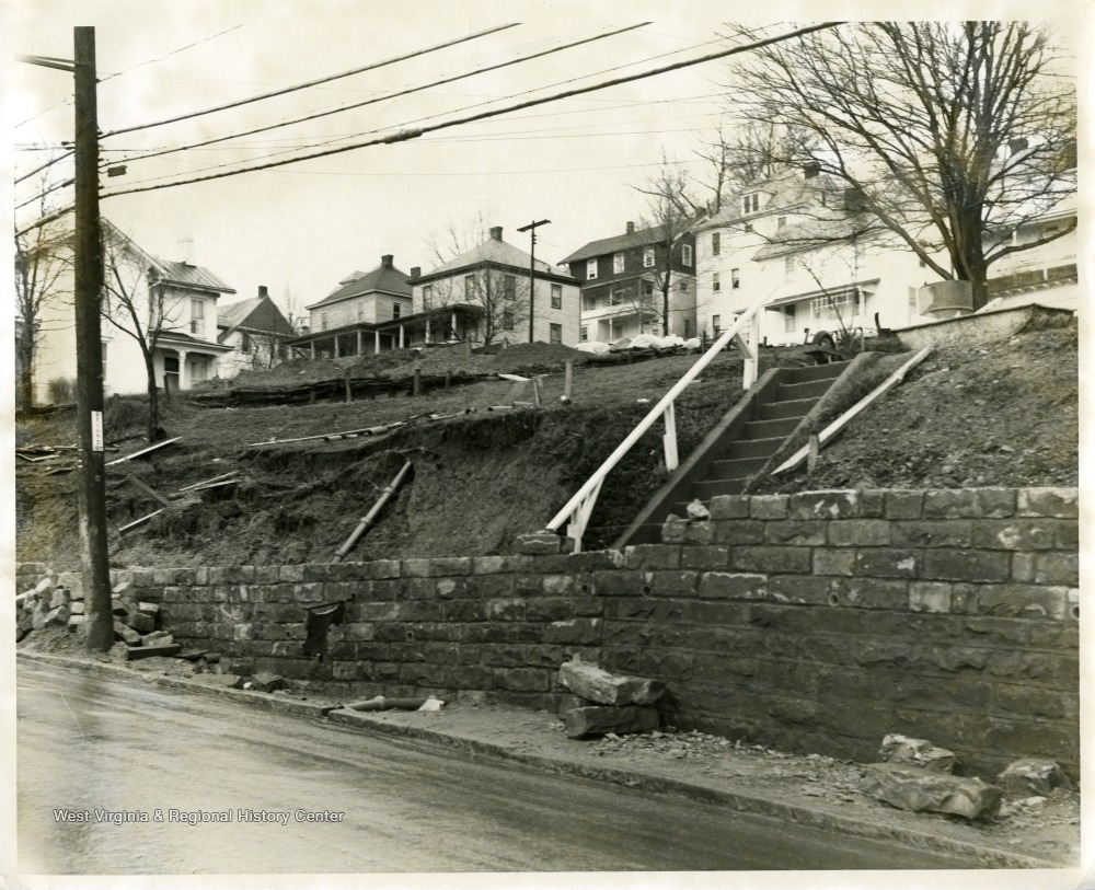 A view of a broken wall and partial sidewalk along University Avenue at Sunnyside in Morgantown, West Virginia.