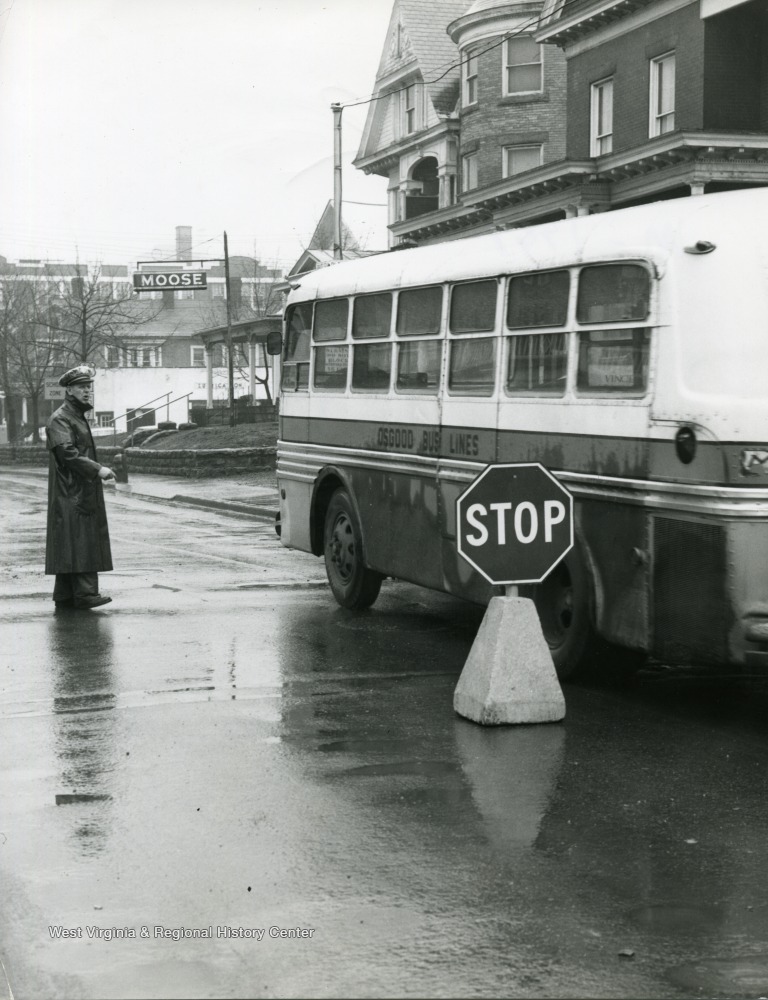 Oscar Clingan is standing in the rain near a Osgood Bus on Spruce Street in Morgantown, West Virginia.