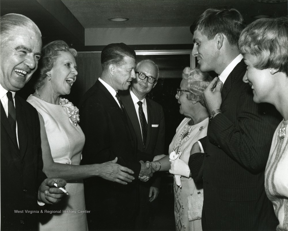 'Scene from the 100th Anniversary reception honoring Dr. and Mrs. Harry B. Heflin.  From left to right are shown: Ralph Bean, president of the WVU Board of Governors; Mrs. Heflin; Dr. Heflin; Donovan H. Bond, Exec. Dir of the 100th Anniversary observance; Mrs. Clifford Brown; David C. Hardesty, former president of the WVU student body; and Susan Brown Hardesty, Mrs. David Hardesty.