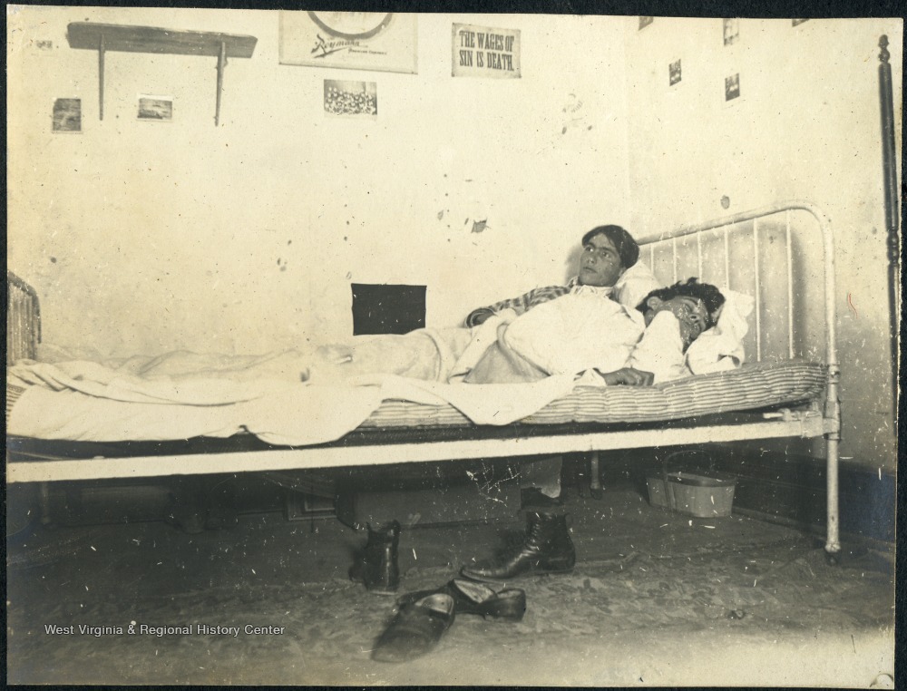 Student Leonard Hall awake in bed next to his sleeping roommate in Episcopal Hall Dormitory. 