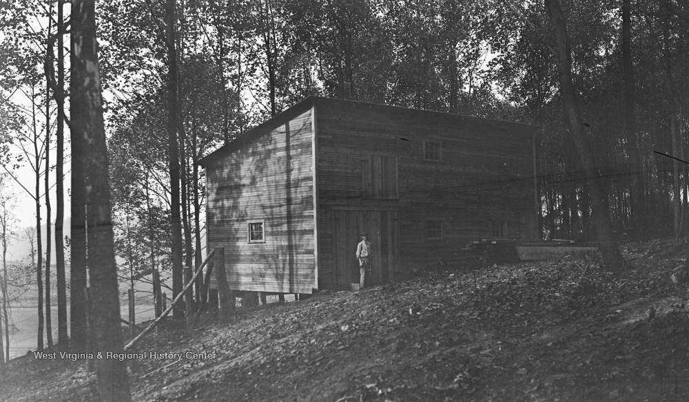 Man Standing Outside Of Cabin In Woods West Virginia History