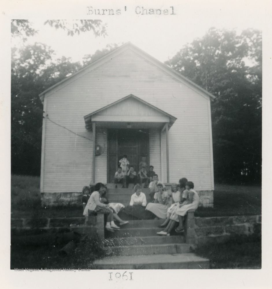 A group of girls sits on the steps of Burns Chapel.  The church was meeting in a school house in 1850.  Plans for a church began in 1906 and building began that summer.  The church was dedicated in 1908.