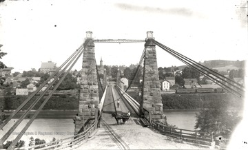 Suspension bridge across the Monongahela River; the viewpoint is from Westover looking toward Morgantown.<br />
