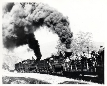 Shay Locomotives No. 1 and 4 pushing people in a cart up a hill. Cass, W.V.