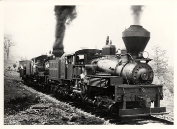Shay trains on tracks. Cass Scenic R.R.; Cass, WV; John P. Killoran, Promotion Office, WV State Parks, Charleston, WV 25305.