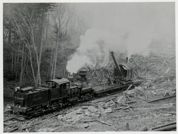 Shay No. 4 train engine pushing/pulling a lumber loading cart.  