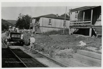 'Cheat Bridge W.Va. near Rt. 250. 1st house, Clyde Folks; 2nd house (high porch), C.P. Gillepsie.  Harlan's mother on porch, with motor car on tracks.'  
