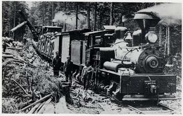 Loading completed, Shay No. 3 prepares to depart a log landing on Cheat Mountain 1904.  In Cab:  Cal Bradley.  On Ground:  1.? 2.? 3.?