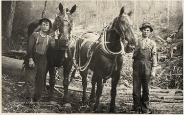 Two men pose with their horses.