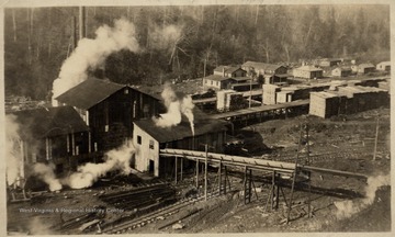 View of lumber mill and lumber piles.