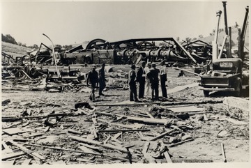 Men inspect the ruins of the Bridgeport Station after a tornado.  