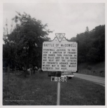 Road sign reading:  'Battle of McDowell  Stonewall Jackson, to prevent a junction of Fremont and Banks, took position on the hills just to the south and beat off the attacks of Fremont's advance under Milroy.  May 8, 1862.  Milroy retreated that night.'  Highland County, Va.