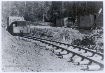 Logging railroad with machinery on the track.