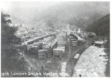 Lumber docks in Horton, W. Va. next to train tracks and river.