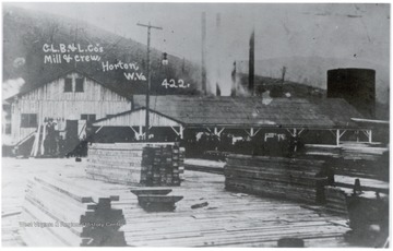 Condon-Lane Boom and Lumber Company mill and crew at Horton, W. Va.  Stacked lumber visible in the foreground.