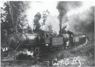 Two engines of C and C railway pulling train.