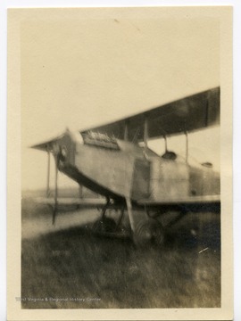 The airplane is a Curtis JN-4 ("Jenny").