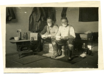 Jarvis Offutt (left) and Orville A Ralston (right), sitting on luggage trunks.  This photograph was found in Bennett's Royal Air Force wallet.  Back of photo says, 'Lou - here you have the picture Bliss took wish you had been in it.  Am ferrying now with H.B [?] at American Officers Inn, London. - Jarvis