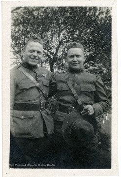 Candid portrait of Orville A Ralston (left) and an unidentified soldier.  This photograph was found in Louis Bennett, Jr.'s Royal Air Force wallet.
