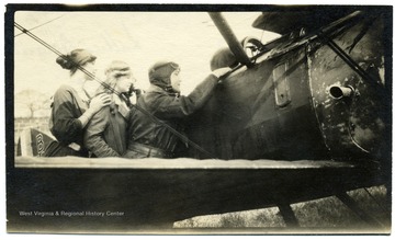 Louis Bennett, Jr. shows his plane to two young ladies, identified on the back of the photo as Lettice Aceland and Ottilie. Portrait of Lt. Louis Bennett, Jr., R.F.C.  This photograph, as well as others (numbers 001378, 001379, and 001380) are referenced in a letter from Mrs. Ethel Mills to Mrs. Louis Bennett, Sr. The text of the letter is as follows: August 20, 1919 Drokes, Beaulieu, Hants My Dear Mrs. Bennett, I just want to reach across the channel, and take your hand and hold it, in a great understanding silence! To begin with, you could not have had my address if your dear boy had not given it!  I hope you will be coming to England [and] will come to us for a few days.  And get to know his old surroundings here -- where he lived [and] bunked.  I remember I was at work building a pig stye! -- when suddenly he appeared flying round [and] round my house and suddenly he made the most beautiful desent [sic] and stood before us, with his handsome face glowing, 'I’ve come to say good bye' -- he could only stay for ½ an hour -- and we mutually photographed each other -- then he was gone, saying 'I’ll send back my photo for you all to sign.'  He had no sooner gone, than I grieved I hadn’t asked him for your address, so as to send you any of ours that might be good, as I knew how you’d love to have as many snapshots as possible, but hoped I’d soon hear from him.  Well at last I did write -- the photo I had to wait sometime to get a signature -- [and] something made me write to him without returning him his [and] ours --  fearing he had moved from his last address -- so I said do tell me if this reaches you before I send the precious photos.'  And I waited, [and] as time passed, I feared he had gone to join with those other warriors!  Then came the trying to find you, [and] send you these precious snapshots. [and] so when I saw your envelope, before I opened it, or had even turned it round, I knew what its contents must be [and] I just felt greatful that evidently he looked upon us as friends, [and] so had given you my name and address.  You will let me see you should you come to England won’t you -- [and] if possible you will come down to Bealieu [and] be with us for a little while. I will not write more tonight -- but with true love [and] the deepest sympathy to Mr. Bennett and yourself. Yours affectionately Ethel Mills You will want his letter too.  You will see the fine way he agitated to get to France and to be fighting!