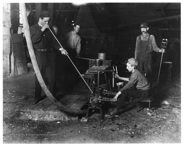 Glass blower and mold boy  with other glass workers in Grafton, West Virginia.  Credit National Archives, 102-LH-151.