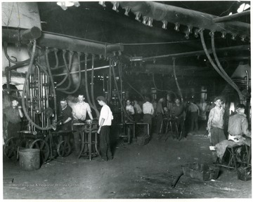 Men working in the Pressing Department of the Fostoria Glass Company.