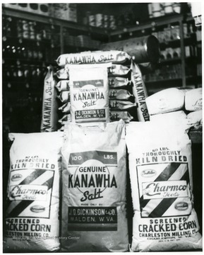Picture of 17 genuine Kanawha Salt Bags from J.Q. Dickinson and Co., Malden, W. Va.  Also bags of Charmco Feeds Screened Cracked Corn from the Charleston Milling Company, Charleston, W. Va.