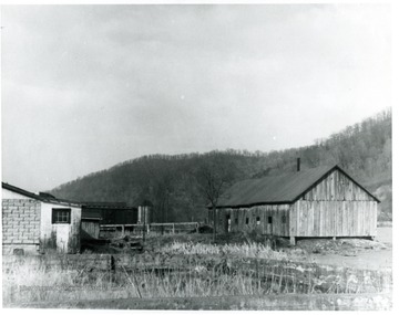 Buildings to the right and left with a silo in the distance.