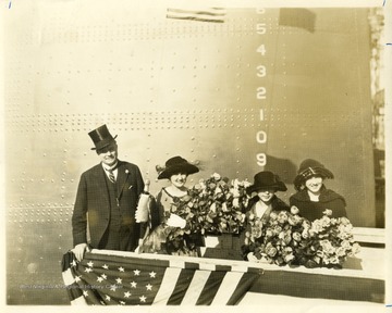 Group portrait of Governor Ephraim Morgan, Alice Wright Mann and others ladies holding bouquets before the christening of the U.S.S. West Virginia.