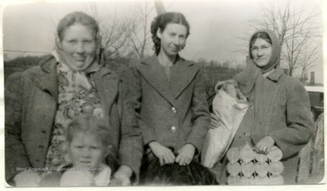 Group portrait of three members of the Marvin Chapel Farm Women's Club taken following a special work meeting on Reconditioning of Furniture. Note: spring unit in hands of member on right.