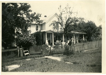 Farm home of W.A. Hirely of Dunmore, W. Va. This later picture shows her new porch posts.  The yard fence pictured has recently been moved out to enlarge the yard and include the foreground.  (See photograph number 001572 for 'before' photograph.)