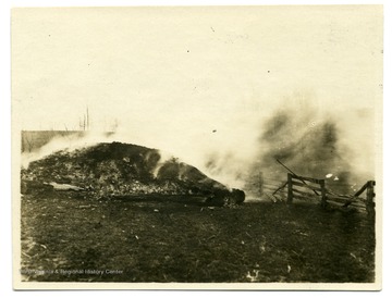 Smoke rising from a burning lime kiln on farm of W. A. Loar, Monongalia County, near Laurel Point, February 11, 1915.