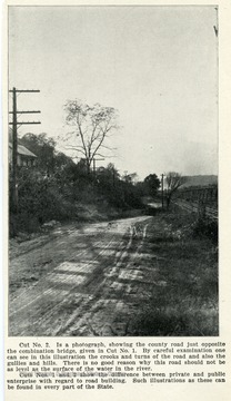 Cut No. 2. Is a photograph, showing the county road just opposite the combination bridge, given in Cut No. 1.  By careful examination one can see in this illustration that crooks and turns of the road and also the gullies and hills.  There is not good reason why this road should not be as level as the surface of the water in the river.  Cuts Nos. 1 and 2 show the difference between private and public enterprise with regard to road building. Such illustrations as these can be found in every part of the state.  See photograph number 001707 for Cut. No. 1.