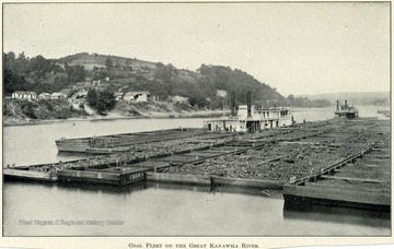 Five barges full of coal lined up on the river.