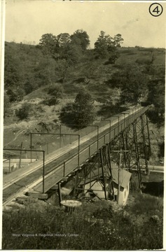 Bridge over a valley leading to a mine entrance.