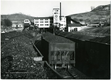 Full loads of coal in train cars in front of the C.C.C. Preparation Plant in Fairmont, W. Va. Credit must be given to William Vandivert, 21 East Tenth St., New York 3, N.Y. 