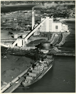 A ship sits in Salem Harbor Dock next to the coal facility.