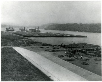 Barges waiting turns on the locks on the Ohio River. Coal barges are filled with 24,000 tons of coal.