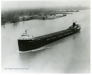 The National Steel Corporation ship,  operated by M.A. Hanna Corporation, on what is likely one of the Great Lakes. The boat was 690 feet long. Ernest T. Weir is written on the side of the ship. Reorder No. from creator is 29786-3.