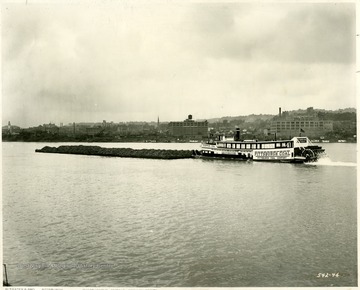 Pittsburgh Coal Co. towboat with a load of coal outside of an unknown city; R.J. Elinhart, Elizabeth, PA.