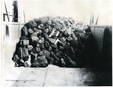 The acid test of coal preparation is to lift your boom to clear and direct the critical eye of the camera against your coal to determine whether or not you are loading your coal properly. This is just what the camera man did in this case. No previous warning or preparation, he just stopped at a tipple, asked the inspector to lift the boom and took this picture. Note again the firmness of this coal in the railroad car; not a trace of slack or impurities. 