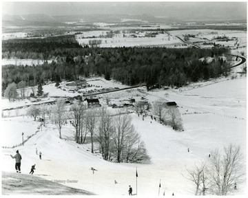 Caption on back reads, 'West Virginia, with the highest average elevation of any state east of the Mississippi River, is making a strong bid to become one of the nations leading winter sports centers. Snow covered mountain slopes like Cabin Mountain, pictured here, overlooking the Canaan Valley, see an average annual snowfall of over five feet. The state now boasts five major winter sports centers located in widely-separated locations.'