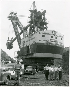 People standing next to the massive Mountaineer shovel.
