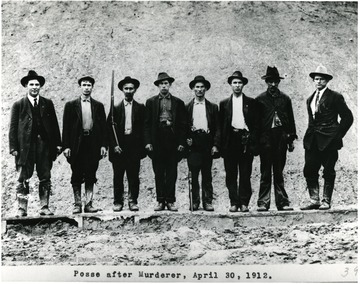 Group portrait of men assembled to catch a murderer.