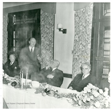 Official giving speech behind dinner table during Consolidation Coal Co.  Inspection trip in 1948.