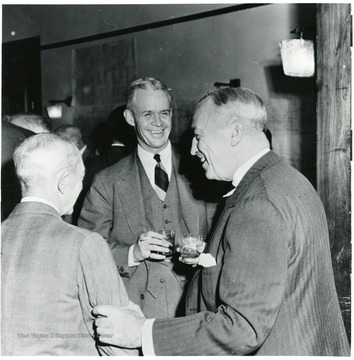 Three men laughing during a Consolidation Coal Co. Inspection trip.